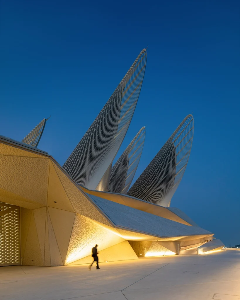 the Zayed National Museum in Abu Dhabi, designed by Foster + Partners, showcasing the five soaring falcon-wing-inspired steel structures and its contextual location in the Saadiyat Cultural District 11