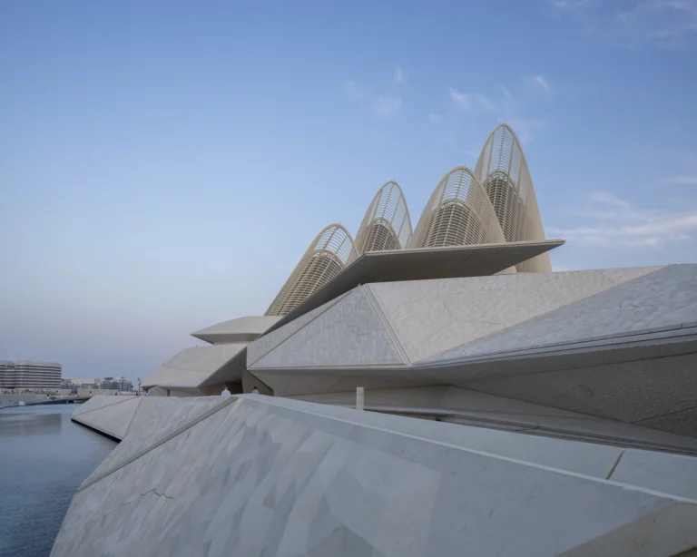 the Zayed National Museum in Abu Dhabi, designed by Foster + Partners, showcasing the five soaring falcon-wing-inspired steel structures and its contextual location in the Saadiyat Cultural District 11