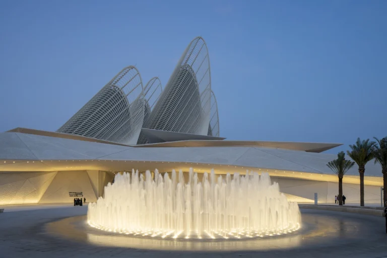 the Zayed National Museum in Abu Dhabi, designed by Foster + Partners, showcasing the five soaring falcon-wing-inspired steel structures and its contextual location in the Saadiyat Cultural District 11