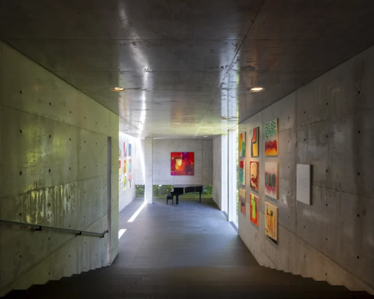 Deed Studio, an award-winning architecture photography studio based in Dubai and the GCC, captures the Koshino House by Tadao Ando—a minimalist concrete home set into a wooded hillside, defined by curved and rectilinear forms and soft natural light filtering through narrow skylights
