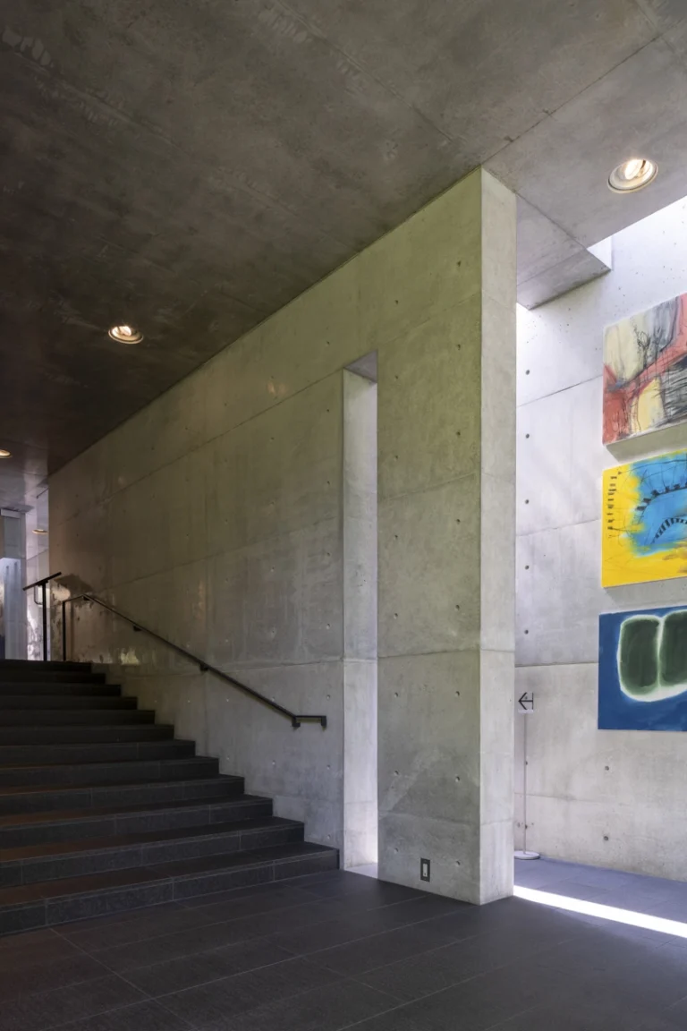 Deed Studio, an award-winning architecture photography studio based in Dubai and the GCC, captures the Koshino House by Tadao Ando—a minimalist concrete home set into a wooded hillside, defined by curved and rectilinear forms and soft natural light filtering through narrow skylights