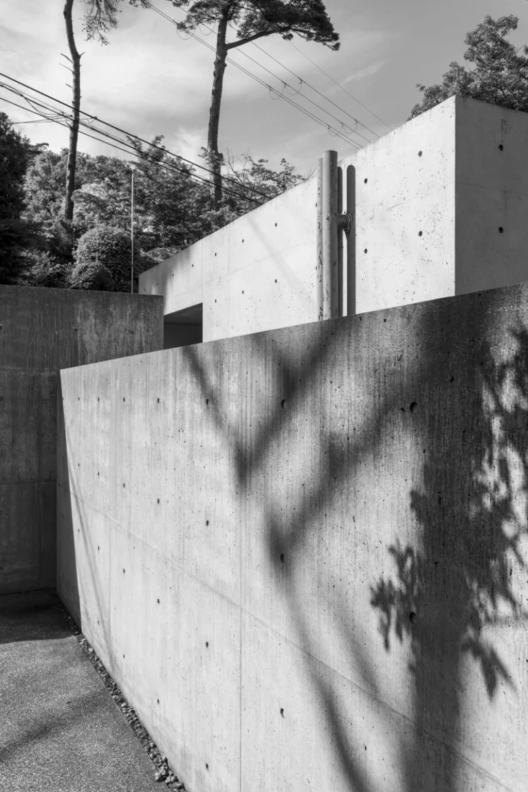 Deed Studio, an award-winning architecture photography studio based in Dubai and the GCC, captures the Koshino House by Tadao Ando—a minimalist concrete home set into a wooded hillside, defined by curved and rectilinear forms and soft natural light filtering through narrow skylights