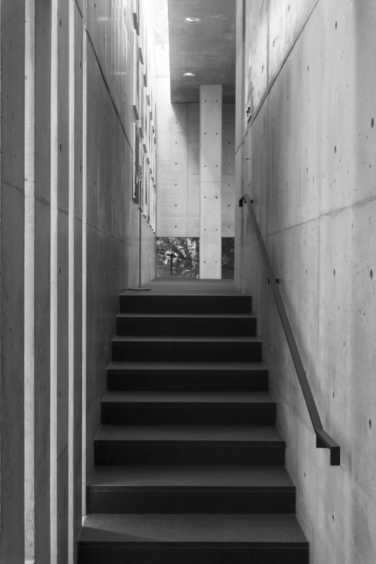 Deed Studio, an award-winning architecture photography studio based in Dubai and the GCC, captures the Koshino House by Tadao Ando—a minimalist concrete home set into a wooded hillside, defined by curved and rectilinear forms and soft natural light filtering through narrow skylights