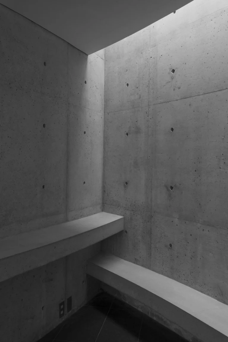 Deed Studio, an award-winning architecture photography studio based in Dubai and the GCC, captures the Koshino House by Tadao Ando—a minimalist concrete home set into a wooded hillside, defined by curved and rectilinear forms and soft natural light filtering through narrow skylights