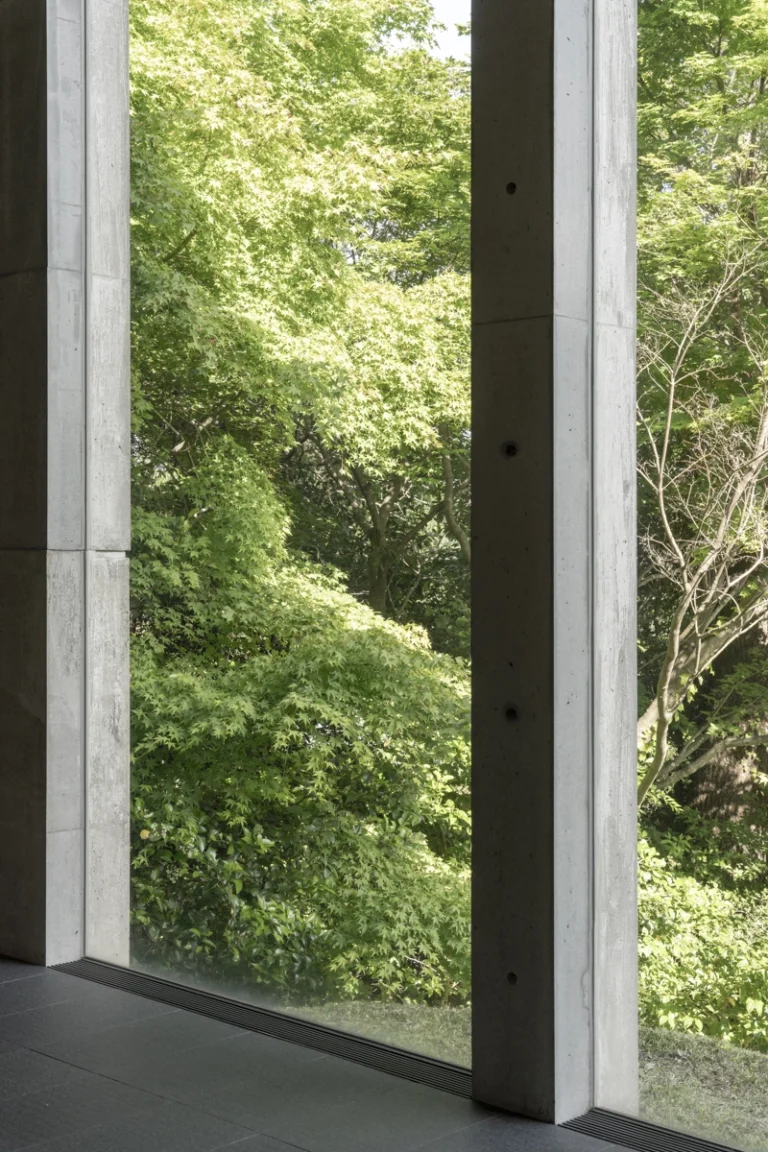Deed Studio, an award-winning architecture photography studio based in Dubai and the GCC, captures the Koshino House by Tadao Ando—a minimalist concrete home set into a wooded hillside, defined by curved and rectilinear forms and soft natural light filtering through narrow skylights