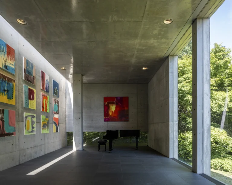 Deed Studio, an award-winning architecture photography studio based in Dubai and the GCC, captures the Koshino House by Tadao Ando—a minimalist concrete home set into a wooded hillside, defined by curved and rectilinear forms and soft natural light filtering through narrow skylights