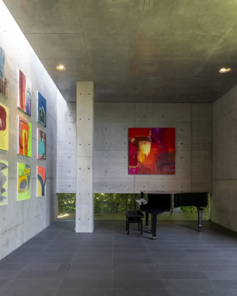 Deed Studio, an award-winning architecture photography studio based in Dubai and the GCC, captures the Koshino House by Tadao Ando—a minimalist concrete home set into a wooded hillside, defined by curved and rectilinear forms and soft natural light filtering through narrow skylights