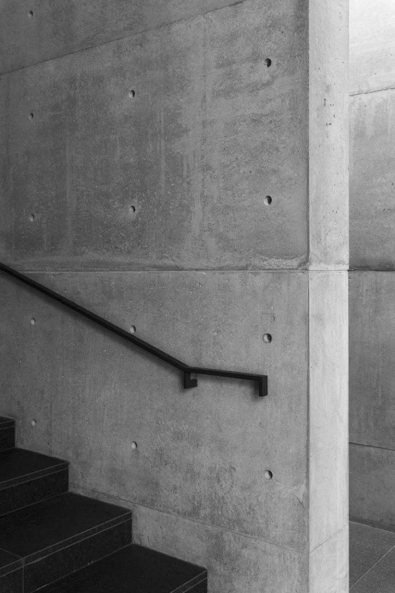 Deed Studio, an award-winning architecture photography studio based in Dubai and the GCC, captures the Koshino House by Tadao Ando—a minimalist concrete home set into a wooded hillside, defined by curved and rectilinear forms and soft natural light filtering through narrow skylights