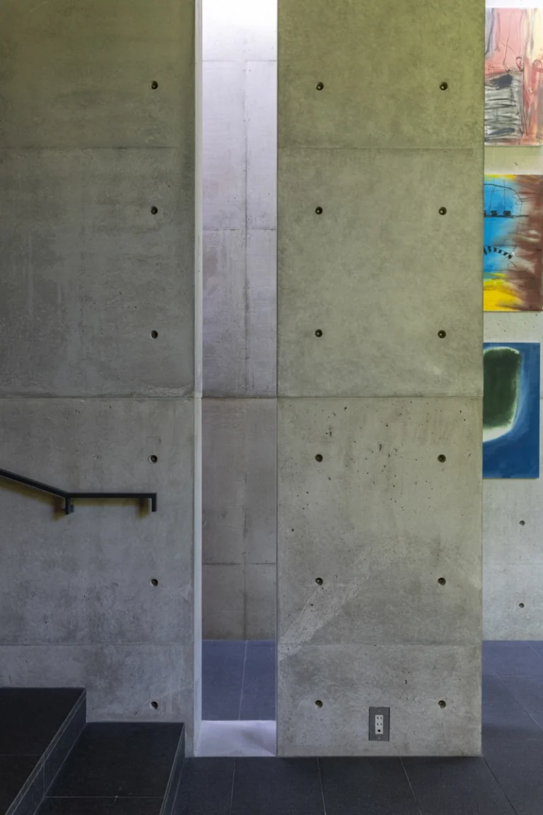 Deed Studio, an award-winning architecture photography studio based in Dubai and the GCC, captures the Koshino House by Tadao Ando—a minimalist concrete home set into a wooded hillside, defined by curved and rectilinear forms and soft natural light filtering through narrow skylights