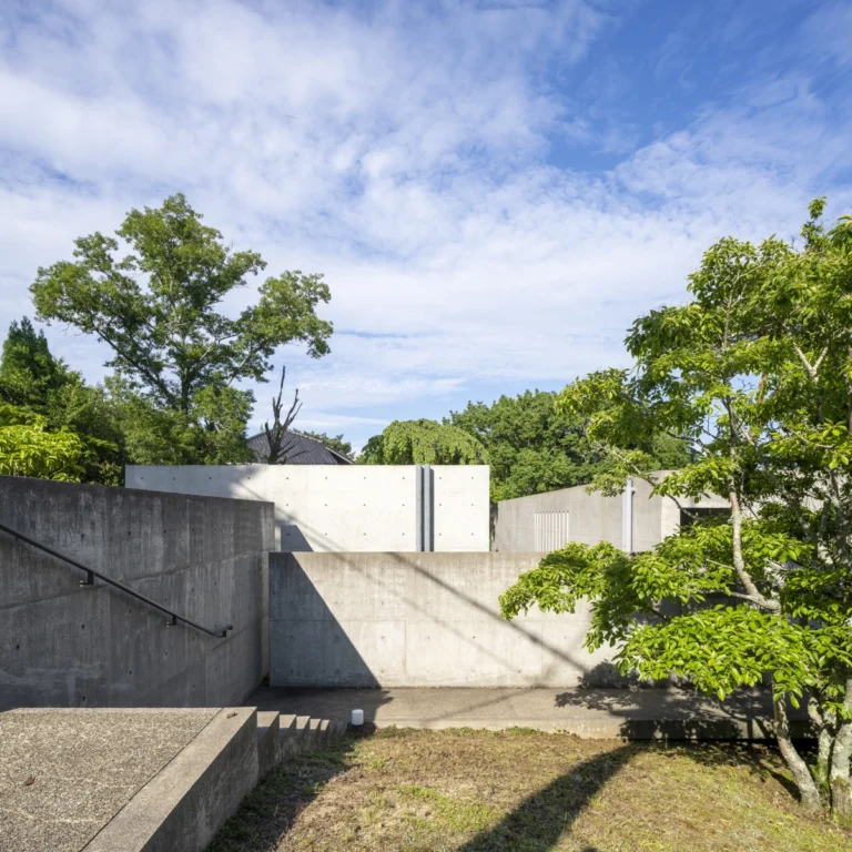 Deed Studio, an award-winning architecture photography studio based in Dubai and the GCC, captures the Koshino House by Tadao Ando—a minimalist concrete home set into a wooded hillside, defined by curved and rectilinear forms and soft natural light filtering through narrow skylights
