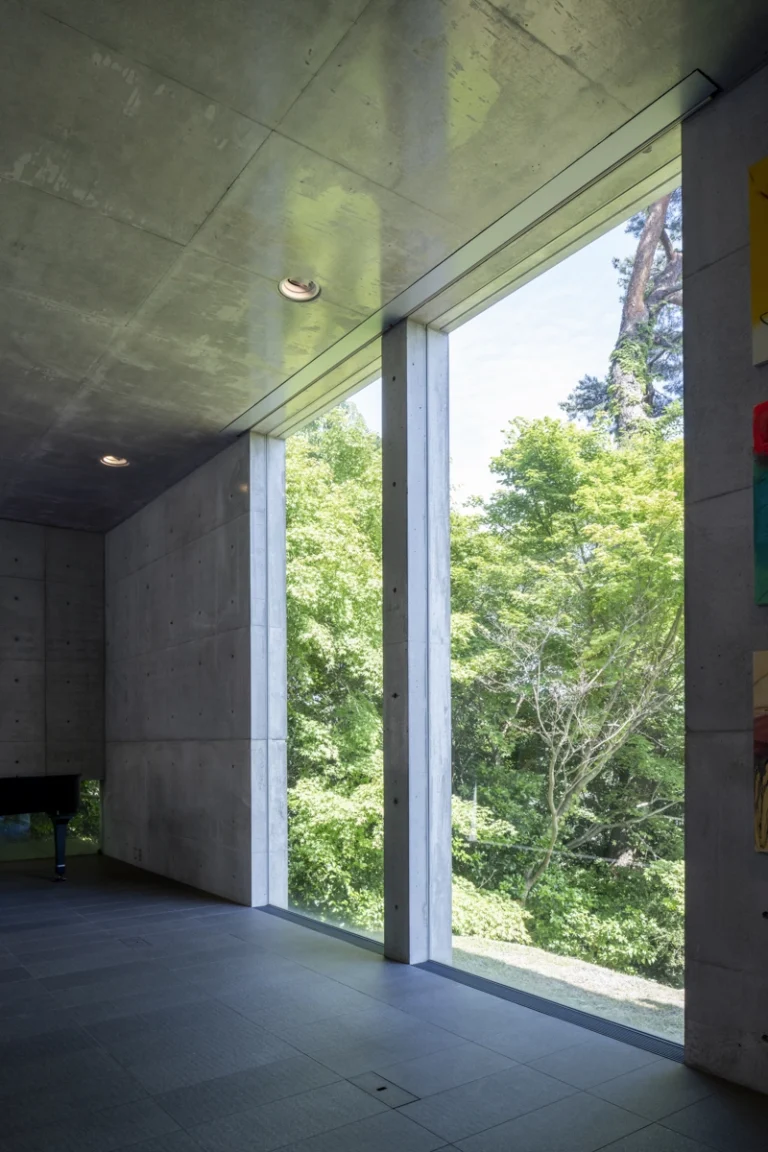 Deed Studio, an award-winning architecture photography studio based in Dubai and the GCC, captures the Koshino House by Tadao Ando—a minimalist concrete home set into a wooded hillside, defined by curved and rectilinear forms and soft natural light filtering through narrow skylights