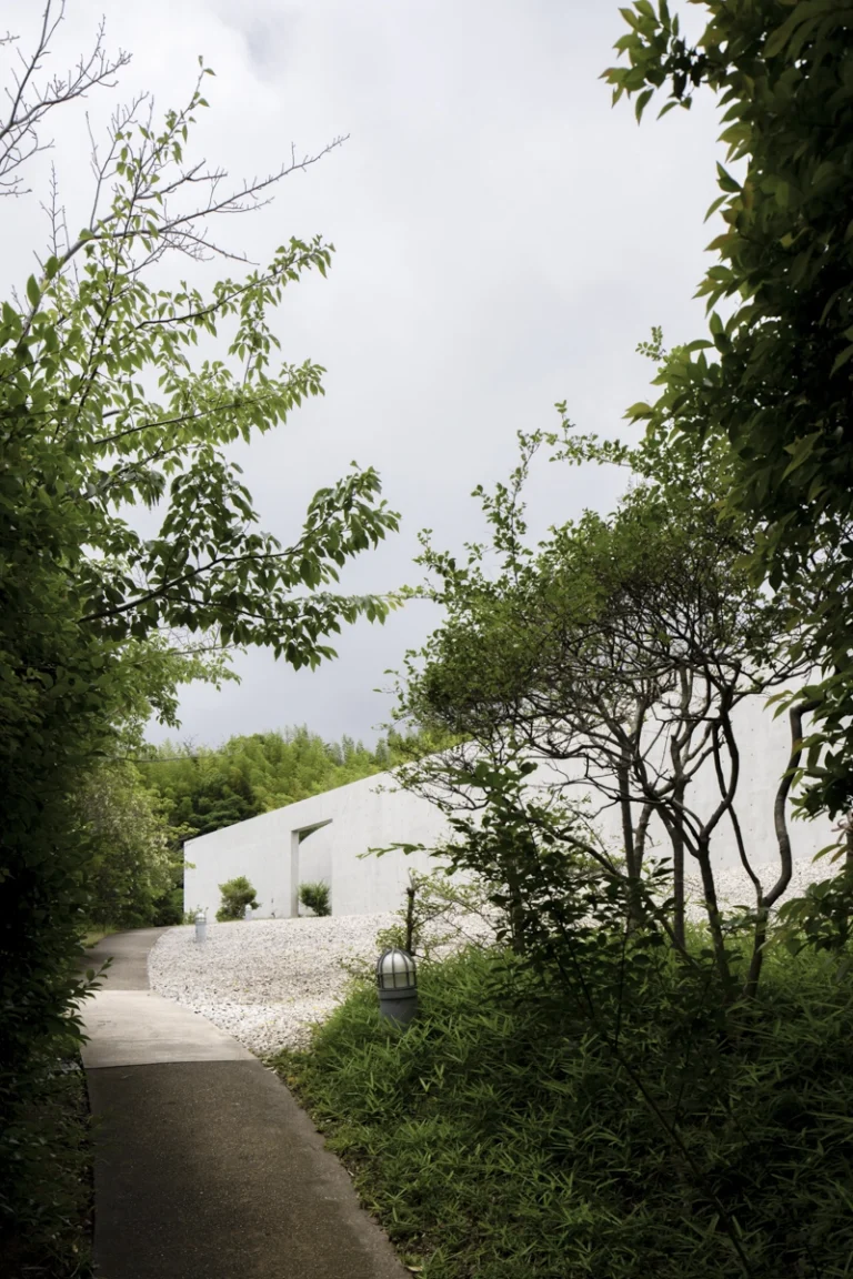 Water Temple in Awaji, Japan designed by Tadao Ando, with a circular lotus pond concealing an underground sanctuary, emphasizing minimalism and spatial sequence.